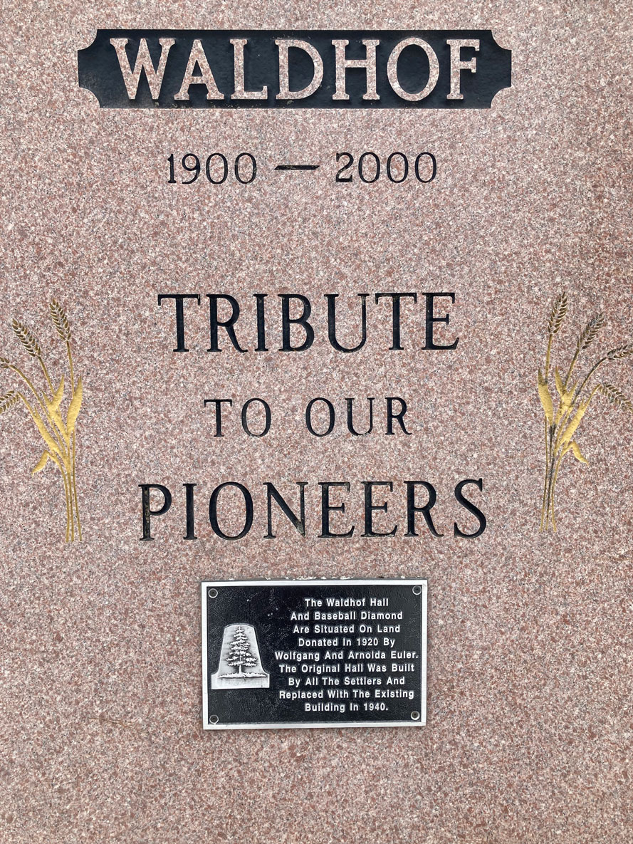 Monument stone and plaque at the entrance to Waldhof Community Hall